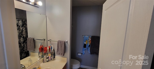 bathroom with vanity and toilet