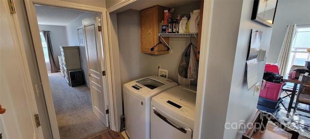 laundry room with cabinets, separate washer and dryer, and carpet