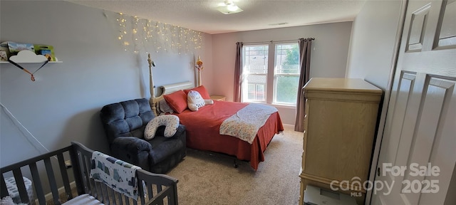 carpeted bedroom featuring a textured ceiling