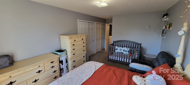 carpeted bedroom with a textured ceiling and a closet