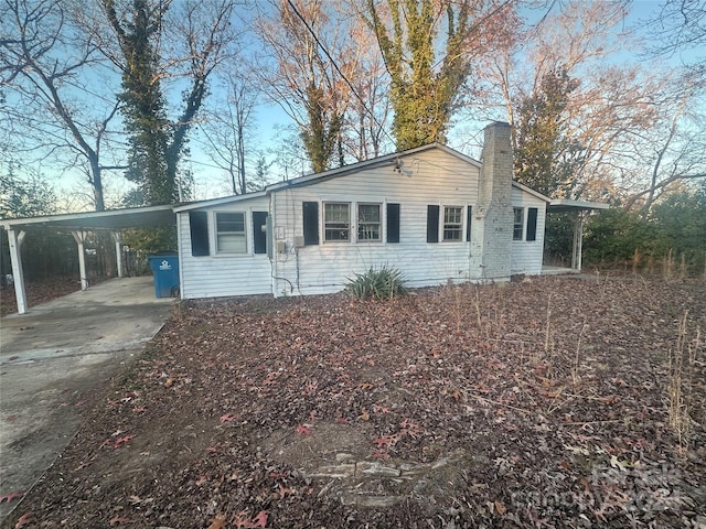 single story home featuring a carport