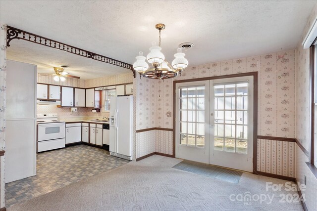 kitchen with carpet, a textured ceiling, white appliances, and white cabinetry