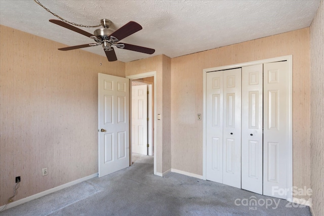 unfurnished bedroom featuring a textured ceiling, a closet, and ceiling fan