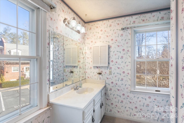 bathroom with vanity, a textured ceiling, and ornamental molding