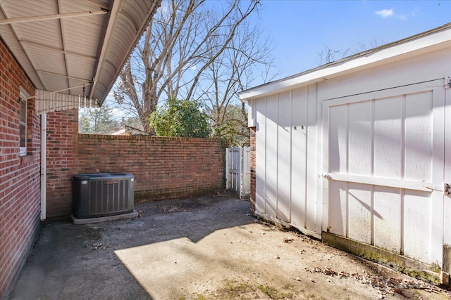 view of patio with cooling unit and a storage unit