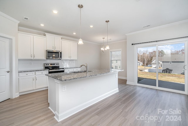 kitchen with white cabinetry, sink, an island with sink, and stainless steel appliances