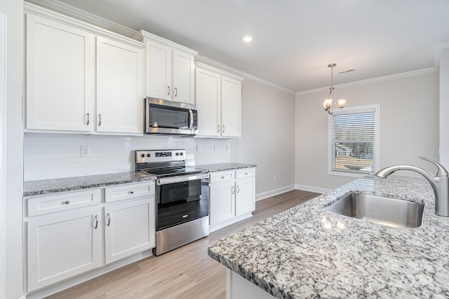 kitchen featuring sink, white cabinetry, stainless steel appliances, and light wood-type flooring