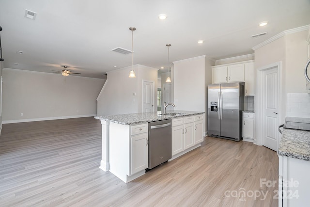 kitchen with stainless steel appliances, ceiling fan, pendant lighting, white cabinets, and light hardwood / wood-style floors