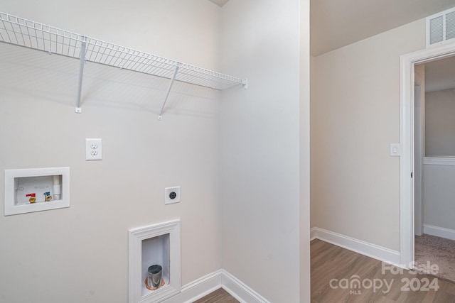 clothes washing area featuring hookup for a washing machine, wood-type flooring, and hookup for an electric dryer