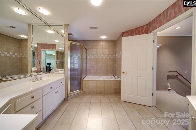 full bathroom featuring a bath, a shower stall, tile patterned flooring, and vanity