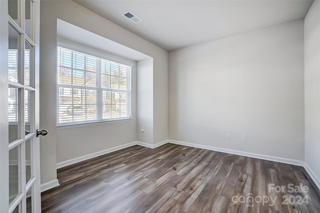 spare room featuring dark hardwood / wood-style flooring