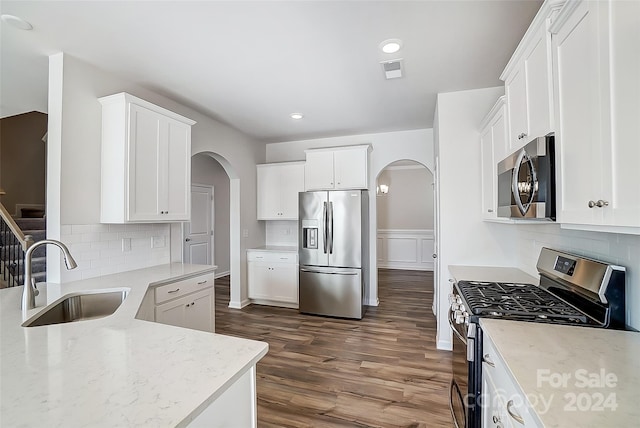 kitchen with white cabinets, dark hardwood / wood-style flooring, sink, and stainless steel appliances