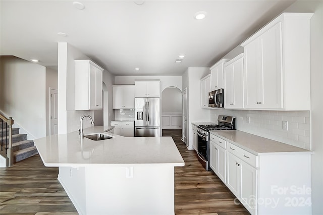 kitchen featuring sink, tasteful backsplash, dark hardwood / wood-style floors, white cabinets, and appliances with stainless steel finishes