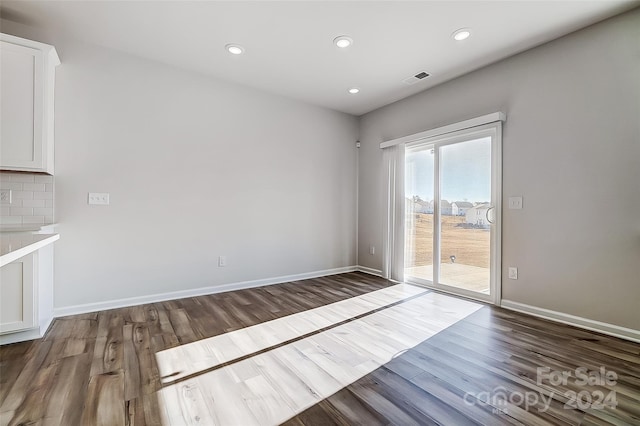 unfurnished room featuring dark hardwood / wood-style floors