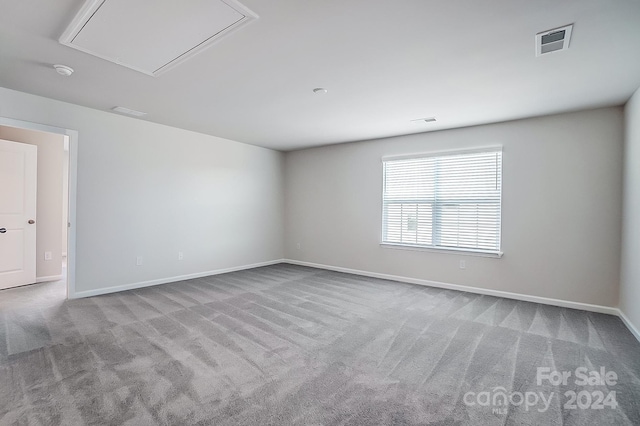 spare room featuring light colored carpet