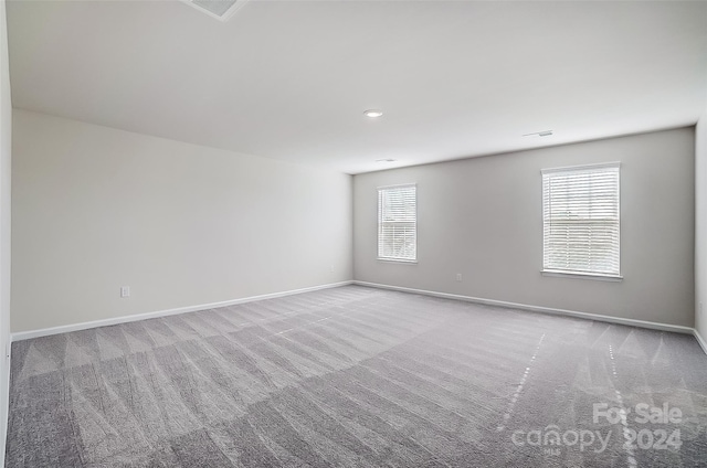 spare room with light colored carpet