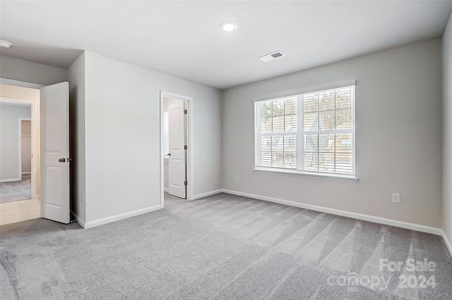 unfurnished bedroom featuring light colored carpet