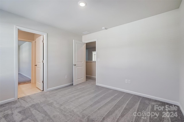 unfurnished bedroom with light carpet