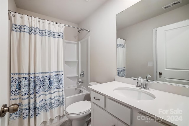 full bathroom featuring vanity, shower / bath combination with curtain, and toilet