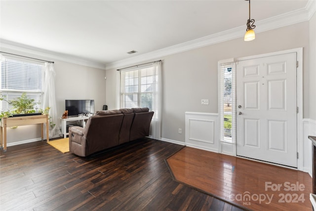 entrance foyer with dark hardwood / wood-style floors and ornamental molding