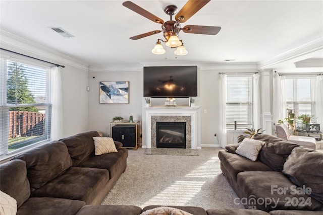 living room with ceiling fan, light colored carpet, and crown molding