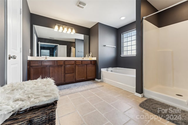 bathroom with tile patterned flooring, vanity, and independent shower and bath