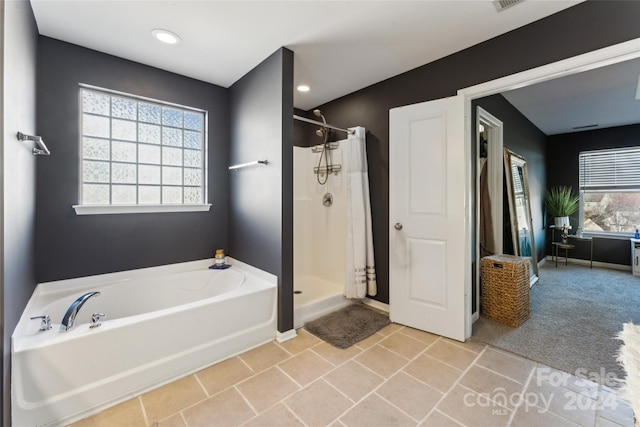 bathroom with tile patterned flooring and independent shower and bath