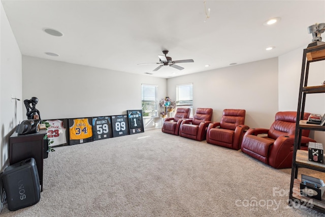 home theater room with ceiling fan and carpet floors