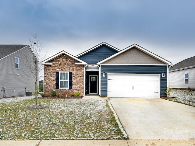 view of front of home with a garage and cooling unit