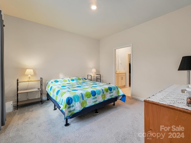 carpeted bedroom with ensuite bathroom