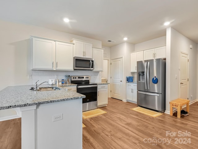 kitchen with white cabinetry, sink, and stainless steel appliances