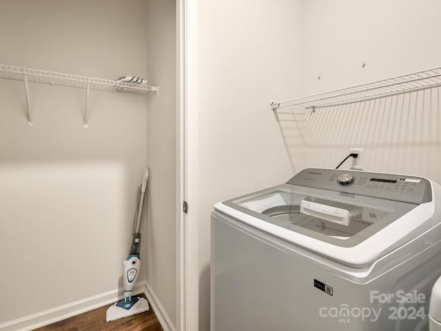 laundry area featuring dark hardwood / wood-style floors and washer / dryer