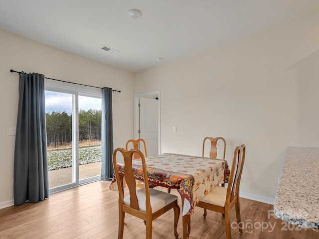 dining space with light hardwood / wood-style floors