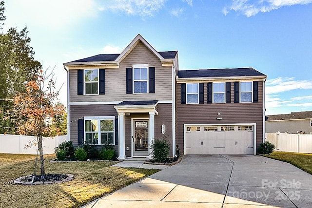 view of front of house featuring a garage and a front yard