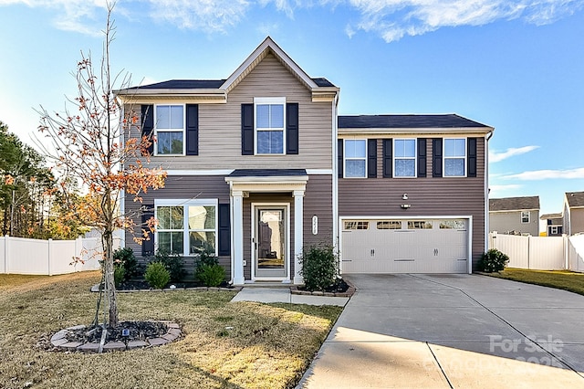 view of front of home featuring a garage and a front lawn