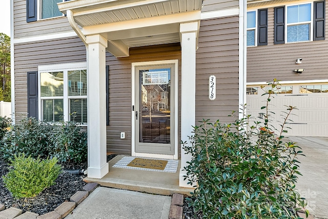 doorway to property with a garage