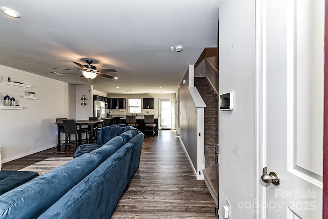 living room with ceiling fan and dark hardwood / wood-style floors