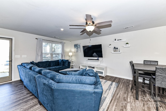 living room with ceiling fan and dark hardwood / wood-style floors