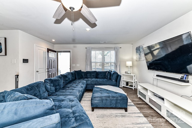 living room with dark hardwood / wood-style flooring and ceiling fan