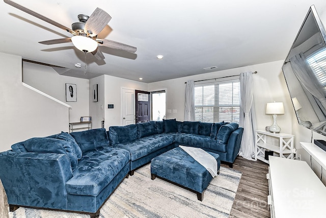 living room with hardwood / wood-style flooring and ceiling fan