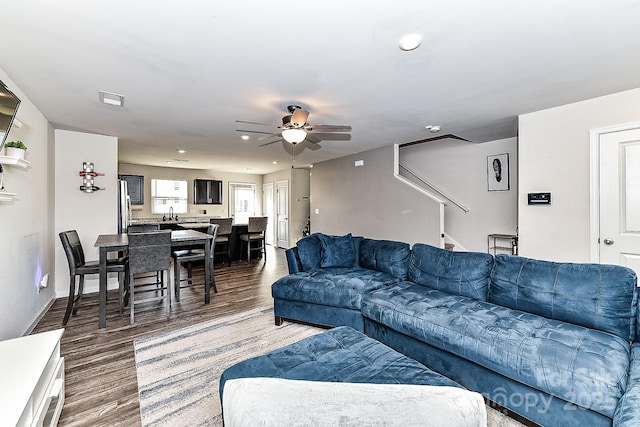 living room with ceiling fan and wood-type flooring