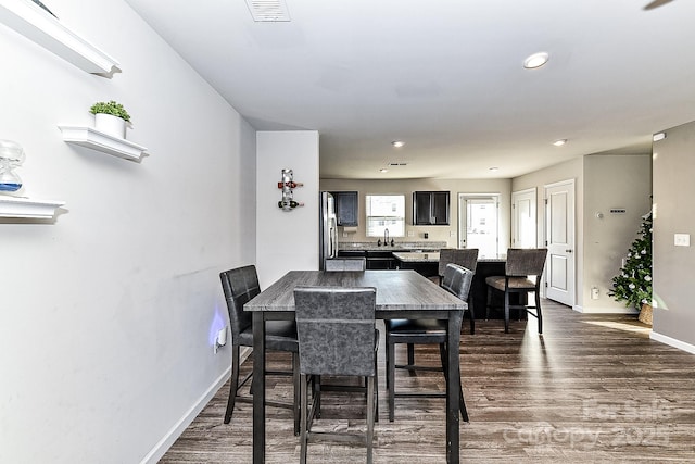 dining area featuring dark wood-type flooring and sink