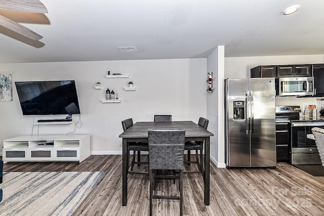 dining space featuring dark hardwood / wood-style floors and ceiling fan