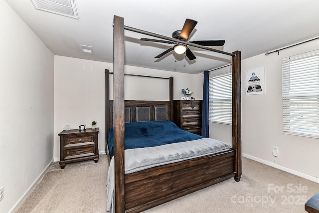 bedroom with ceiling fan and light carpet