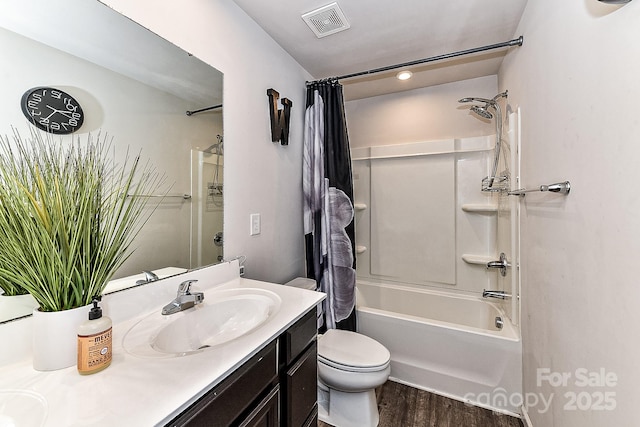 full bathroom featuring vanity, toilet, wood-type flooring, and shower / tub combo