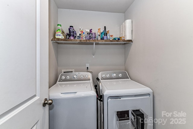 clothes washing area featuring separate washer and dryer