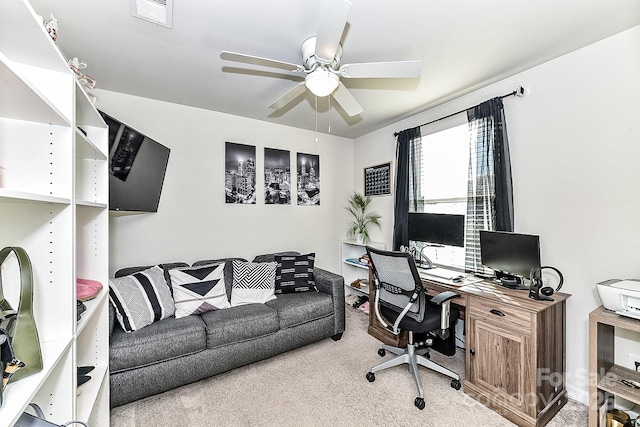 office space featuring ceiling fan and light colored carpet