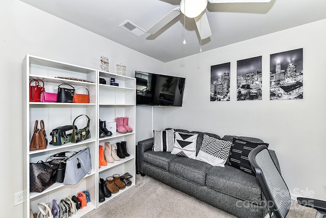 living room with ceiling fan and light colored carpet