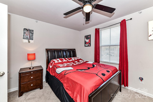 bedroom with ceiling fan and light carpet