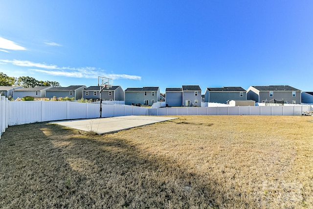 view of yard featuring basketball hoop